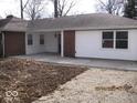 Covered back patio with brick and siding finishes, perfect for outdoor entertaining at 3008 W Grace Ln, Muncie, IN 47304
