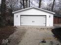 Detached white garage with a two-car garage door and decorative black hardware at 3008 W Grace Ln, Muncie, IN 47304