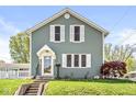 Charming home features a well-manicured lawn, white trim, and a decorative front door at 315 W High St, Pendleton, IN 46064