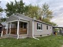 Side view of home showing siding, windows, and covered porch at 357 N 18Th Ave, Beech Grove, IN 46107