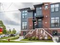Modern townhome with red brick, gray siding, multiple windows, and landscaped front yard at 401 Jersey St, Westfield, IN 46074