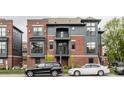 Modern townhome with red brick, gray siding, multiple windows, and landscaped front yard at 401 Jersey St, Westfield, IN 46074