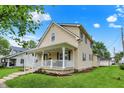 Attractive two-story home with a welcoming front porch and manicured lawn at 410 E North St, Greenfield, IN 46140