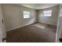 Bedroom featuring neutral walls and carpet, with two windows offering natural light at 4109 East 21St St, Indianapolis, IN 46218