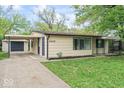 View of home with carport, featuring a concrete driveway and a well-manicured lawn at 4432 Brittany Rd, Indianapolis, IN 46222