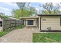 Side view of home with carport, featuring a concrete driveway and green lawn at 4432 Brittany Rd, Indianapolis, IN 46222
