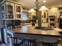 Well-equipped kitchen featuring updated appliances, granite countertops, and a center island with seating at 448 Tamarack Ln, Noblesville, IN 46062