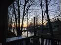 Scenic view of a lake from a private deck surrounded by lush trees and serene waters at 448 Tamarack Ln, Noblesville, IN 46062