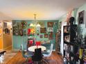 Bright dining room featuring unique decor, a modern chandelier, and hardwood flooring at 4820 Nowland Ave, Indianapolis, IN 46201
