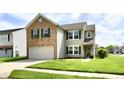 Lovely home showcasing a well-maintained lawn and beautiful architecture with a two-car garage at 5005 Whisenand Dr, Indianapolis, IN 46254