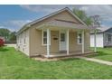 Welcoming single-story home with covered porch and well-kept lawn at 52 N Ross St, Columbus, IN 47201