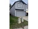 Charming two-story home with gray vinyl siding, complemented by a well-maintained lawn at 562 Harmony Dr, Greenwood, IN 46143