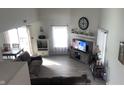 Well-lit living room with a fireplace, modern flooring, and cozy seating area at 562 Harmony Dr, Greenwood, IN 46143