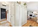 Bright hallway with built-in storage and hardwood floors leading to living area at 5987 E 100 N, Franklin, IN 46131