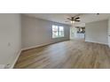 Spacious living room boasts hardwood floors, a ceiling fan, and seamlessly flows into the adjacent kitchen at 6420 Greenspire Pl, Indianapolis, IN 46221