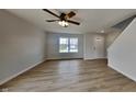 Bright, open-concept living room featuring hardwood floors and a large window allowing ample natural light at 6420 Greenspire Pl, Indianapolis, IN 46221