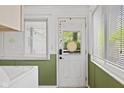 Bright white door featuring a window and a white frame, with decorations and views to the outdoors at 7 Lake Hart, Mooresville, IN 46158