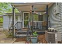 Inviting front porch with chairs and decor, accessible by a small set of stairs with railings and plants at 7 Lake Hart, Mooresville, IN 46158