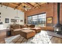 Spacious living room featuring exposed brick walls, wood ceilings, and modern furnishings at 735 Lexington Ave # Apt 27, Indianapolis, IN 46203