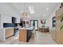Modern kitchen with a large island, stainless steel appliances, and a skylight for natural light at 8049 Burn Ct, Indianapolis, IN 46217