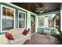 Inviting enclosed front porch with tiled flooring, comfortable seating, and plenty of natural light at 844 N Emerson Ave, Indianapolis, IN 46219