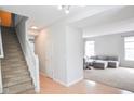 Welcoming foyer with staircase and an open view to the carpeted living room at 9718 Jupiter Pass, Carmel, IN 46032