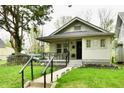Inviting single-story home features a cozy front porch with ample seating at 1014 W 32Nd St, Indianapolis, IN 46208
