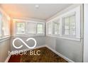 Bright sunroom with many windows and hardwood floors at 1014 W 32Nd St, Indianapolis, IN 46208