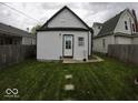 This backyard features a lush lawn and an accessory dwelling unit in the rear at 1035 Albany St, Indianapolis, IN 46203