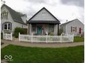Exterior shot of a cute house with a white picket fence surrounding the front yard at 1035 Albany St, Indianapolis, IN 46203