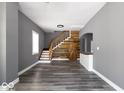 Open-concept living space features hardwood floors, modern paint, and a stylish staircase at 1035 Albany St, Indianapolis, IN 46203