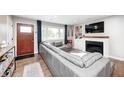 Cozy living room with a large sectional sofa, fireplace, built-in shelving, and plenty of natural light at 10805 Charlemagne Dr, Indianapolis, IN 46259