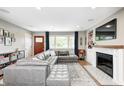 Inviting living room features a plush sectional sofa, fireplace, and stylish decor at 10805 Charlemagne Dr, Indianapolis, IN 46259