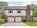Two-car garage and basketball hoop at 1106 Fox Trail W Dr, New Palestine, IN 46163