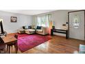 Bright living room featuring hardwood floors, natural light, and a comfortable sectional sofa at 1225 N Graham Ave, Indianapolis, IN 46219