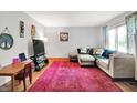 Inviting living room with hardwood floors, a comfortable sectional, and a large window at 1225 N Graham Ave, Indianapolis, IN 46219