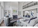 Bright, expansive living room with fireplace and built-in shelving at 12399 Lynnwood Blvd, Carmel, IN 46033