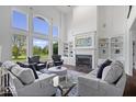 Bright living room with soaring ceilings, fireplace and large windows at 12399 Lynnwood Blvd, Carmel, IN 46033