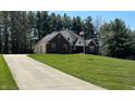 Charming home with a spacious yard, mature trees, and an American flag waving in the breeze at 125 W Chalet Dr, Mooresville, IN 46158