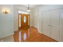 Welcoming foyer with gleaming hardwood floors and a wooden door with decorative glass at 1297 Morningside Dr, Greenfield, IN 46140