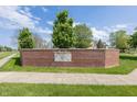 Exterior shot of the brick Cricket Reel neighborhood sign with trees in the background and a sidewalk in front at 1297 Morningside Dr, Greenfield, IN 46140