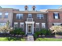 Inviting townhouse front with landscaped garden and charming brick facade at 13499 Molique Blvd, Fishers, IN 46037