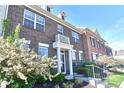 Beautiful brick townhome boasts a well-manicured front yard and welcoming entrance at 13499 Molique Blvd, Fishers, IN 46037
