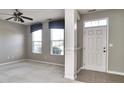 Bright, airy living room featuring neutral walls, a ceiling fan, and a light-filled window at 13499 Molique Blvd, Fishers, IN 46037