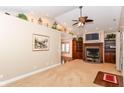 Spacious living room featuring a cozy fireplace, large shelving, and vaulted ceilings at 1426 S Anderson St, Elwood, IN 46036