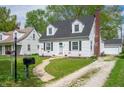 Classic home featuring a well-kept lawn and a paved walkway leading to the front entrance at 155 N Franklin Rd, Indianapolis, IN 46219