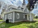 Lovely home featuring gray siding, white trim, and well-maintained landscaping at 1715 S Madison St, Muncie, IN 47302