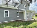 Inviting covered entryway with white columns and a gray exterior, offering curb appeal at 1715 S Madison St, Muncie, IN 47302
