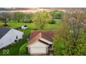 An aerial view of a charming single-story home surrounded by lush greenery and a well-manicured lawn at 2154 Walnut Meadow Ct, Indianapolis, IN 46234