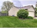 Well-maintained backyard with a lush lawn, privacy fence, and mature landscaping at 2154 Walnut Meadow Ct, Indianapolis, IN 46234